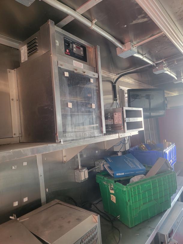 Interior view of 2021 Titanium Cargo 28' Mobile Kitchen with commercial-grade equipment, including Menumaster ovens.