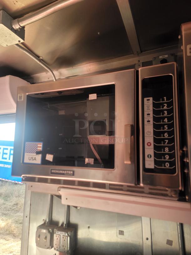 Menumasters oven inside a 2021 Titanium Cargo mobile kitchen. Features keypad controls and a USA sticker, ideal for high-volume use.