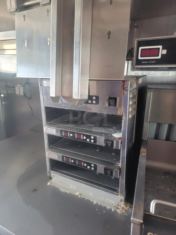 2021 Triple Axle Mobile Kitchen with Garland Clamshell Grills and Henny Penny Fryers. Stainless steel interior.
