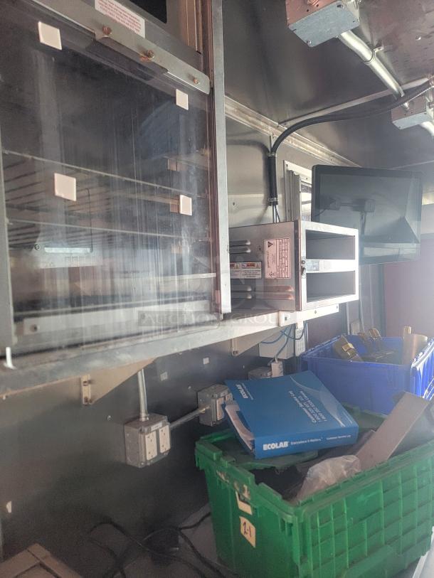 2021 Titanium Cargo 28' Mobile Kitchen interior with commercial-grade Menumaster ovens, electrical panels, and storage bins.