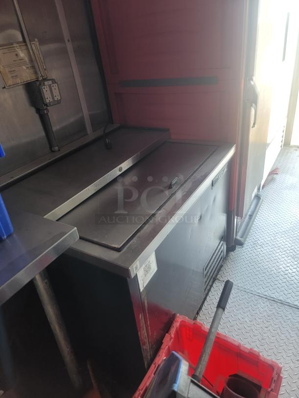 2021 Titanium Cargo 28' Mobile Kitchen interior, showing commercial-grade equipment setup, electrical panel, and metal surfaces.