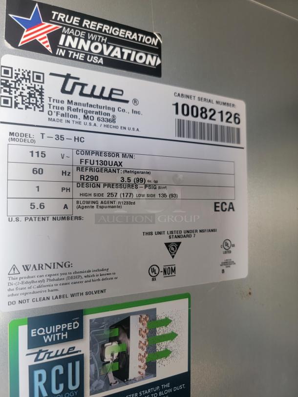 Label on a True Manufacturing refrigeration unit shows model T-35-HC, compressor FFU130UAX, and refrigerant R290.