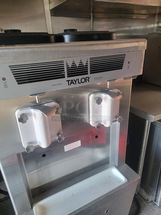 Taylor soft-serve machine inside a 28' Mobile Kitchen. Features include Garland grills and Henny Penny fryers.