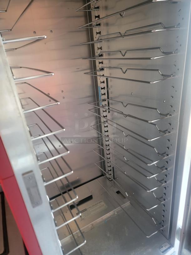Interior of a Titanium Cargo 28' mobile kitchen, featuring stainless steel shelving and commercial-grade fittings for heavy-duty use.