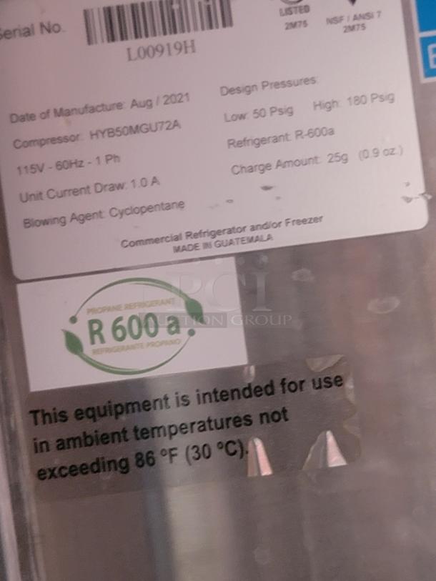 Label on a commercial refrigerator indicating model HYB50MGU72A, uses R-600a refrigerant, made in Guatemala.