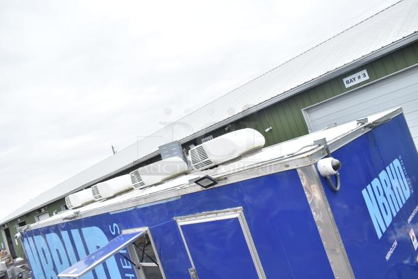 2021 Rock Solid Cargo 24' fast food trailer, blue exterior, branded "NBRHD Kitchens," featuring rooftop AC units.