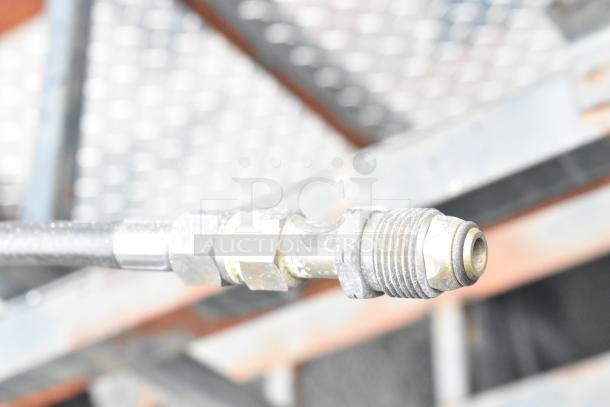 Close-up of a metallic hose connector on a 2021 Rock Solid Cargo mobile kitchen trailer.