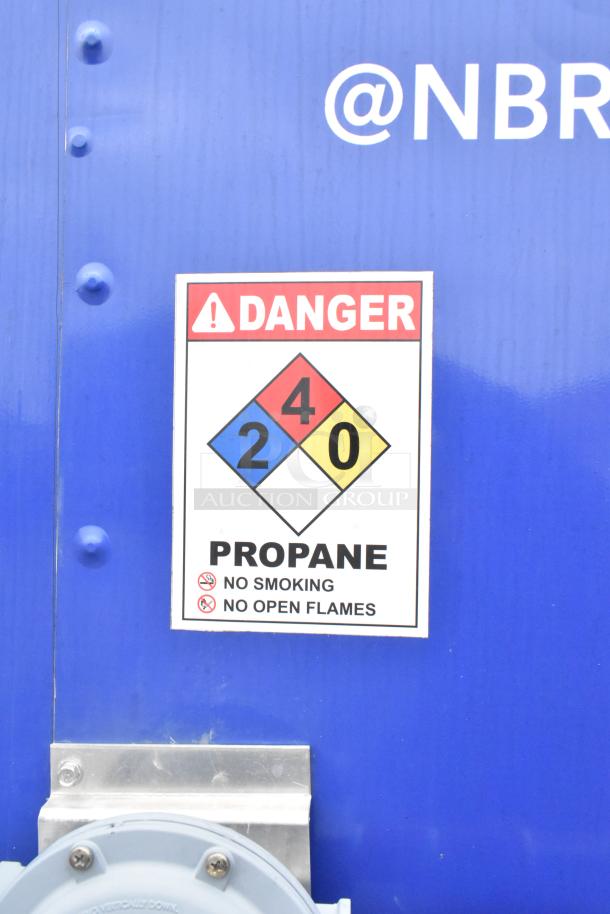 Blue trailer with propane hazard label displaying "DANGER 240," warning "No Smoking, No Open Flames."