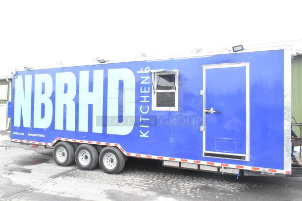 Blue 2021 Rock Solid Cargo 24' fast food trailer, branded "NBRHD Kitchens," equipped with new commercial kitchen appliances.