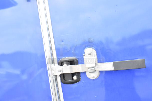 Blue Rock Solid Cargo trailer door handle and latch detail, indicating secure locking mechanism.