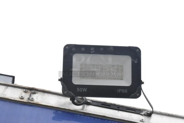 50W IP66 outdoor LED floodlight mounted on the exterior of a mobile kitchen trailer.