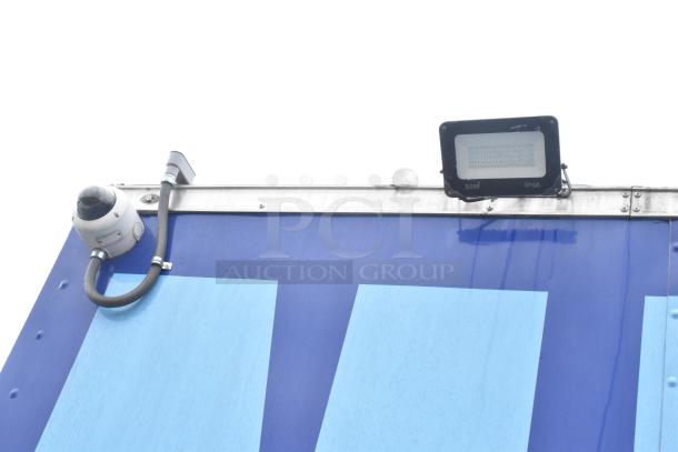 Rock Solid Cargo 24' fast food trailer top view, featuring a security camera and 50W IP66 floodlight. Durable design, blue exterior.