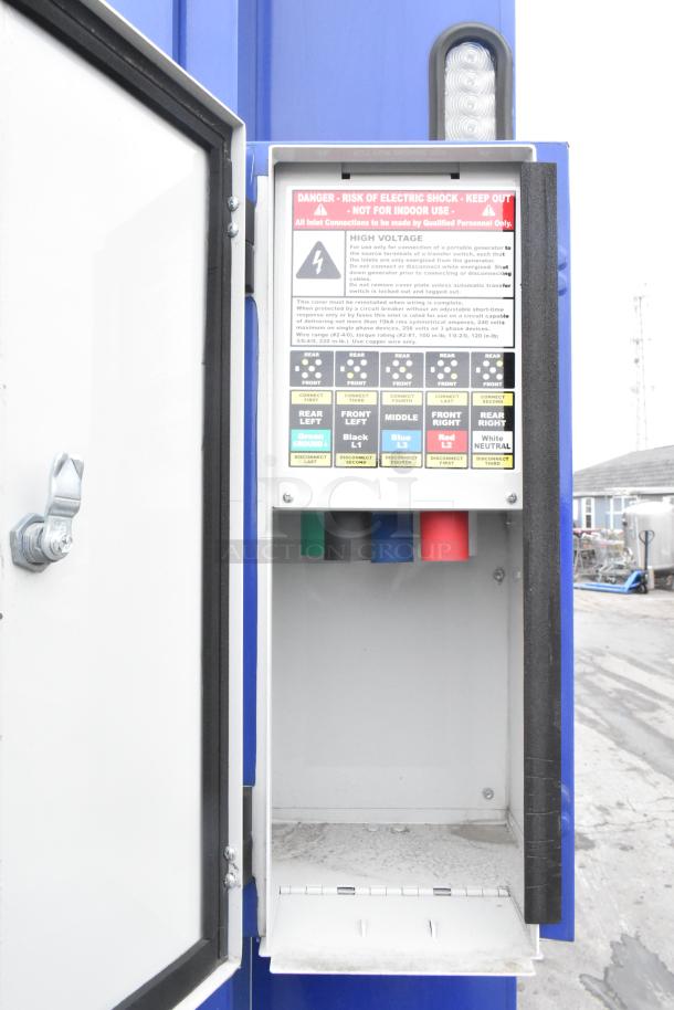 Electrical panel inside Rock Solid Cargo trailer, showing high voltage instructions, color-coded connections, and warning labels.