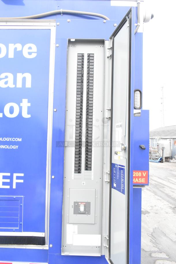 Rock Solid Cargo 24' food trailer power panel open, showing circuit breakers and a 208V phase label. Mint condition.