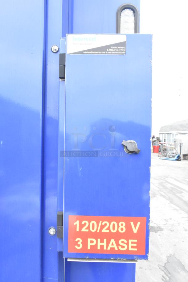 Blue control panel on a 2021 Rock Solid Cargo trailer. Label indicates "120/208 V 3 Phase." Intersect contact info.
