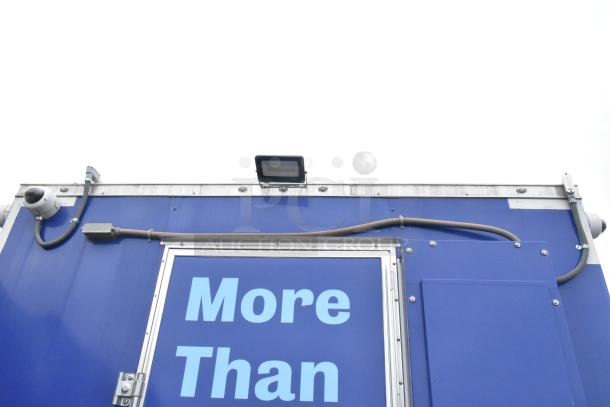 Rock Solid Cargo 24' blue mobile kitchen trailer, brand new, equipped with commercial-grade appliances, ideal for fast food.