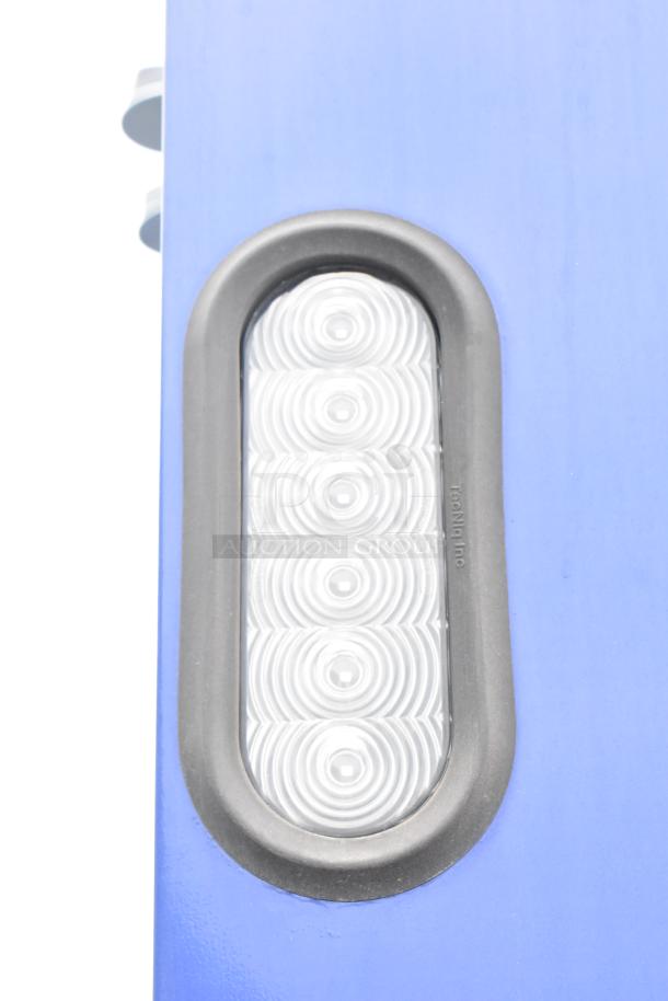 Blue Rock Solid Cargo trailer detail showing a patterned oval light with the marking "TecNiq Inc."