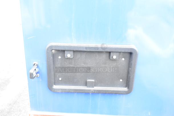 Rock Solid Cargo fast food trailer, blue exterior, unused, includes license plate frame and lockable handle.