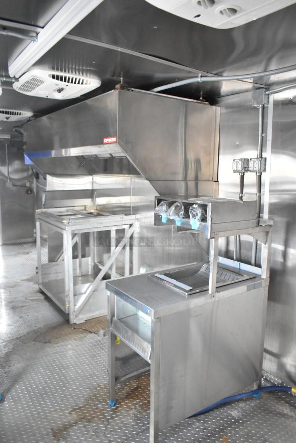 Rock Solid Cargo 24' mobile kitchen trailer with CaptiveAire hood, stainless steel fixtures, and commercial-grade appliances.