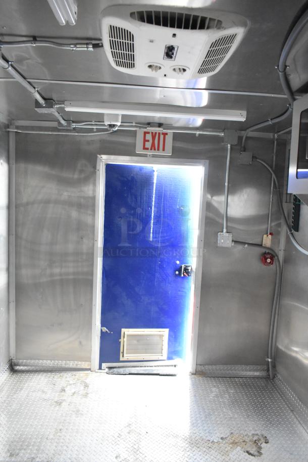 2021 Rock Solid Cargo 24' trailer interior with blue exit door, ceiling air unit, and diamond plate flooring. Brand new condition.