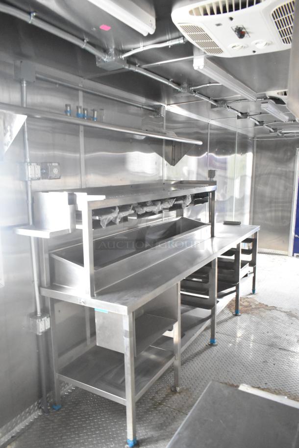 Brand new 2021 Rock Solid Cargo 24' fast food trailer interior with stainless steel counters, ventilation, and commercial equipment.