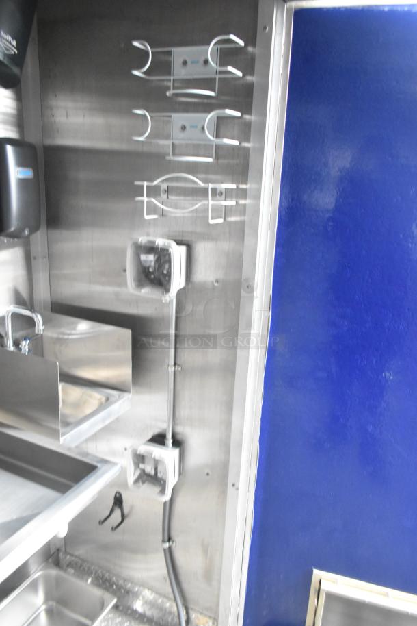 Brand new 2021 Rock Solid Cargo 24' commercial kitchen trailer interior. Features stainless steel sinks, grease hood, and dispensers.