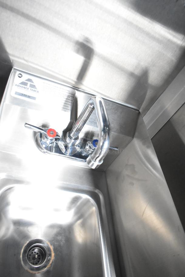 Stainless steel Advance Tabco sink with dual temperature controls inside Rock Solid Cargo food trailer.