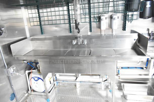 Brand new 2021 Rock Solid Cargo 24' fast food trailer kitchen, featuring a stainless steel sink and CaptiveAire grease hood.