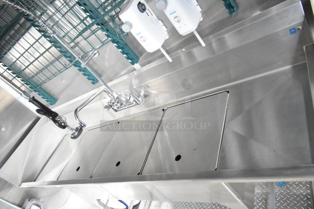 Brand new stainless steel triple sink in Rock Solid Cargo food trailer, featuring commercial-grade fixtures.