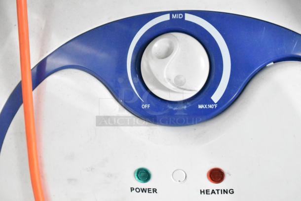 Close-up of controls with blue dial marked from Off to Max 140°F, and green and red indicator lights labeled Power and Heating.