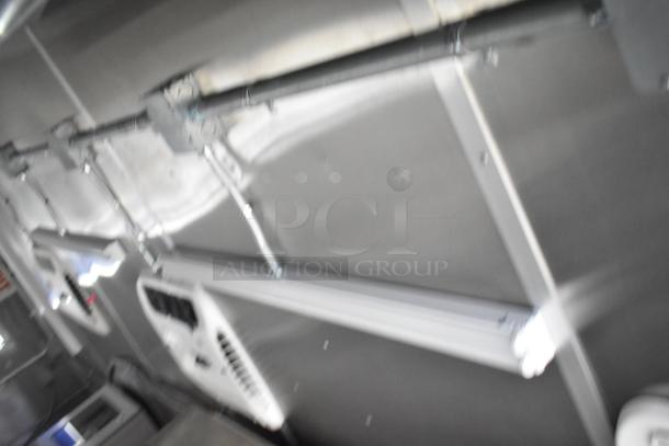 Rock Solid Cargo 24' mobile kitchen interior view with commercial-grade equipment, including CaptiveAire grease hood. Brand new condition.