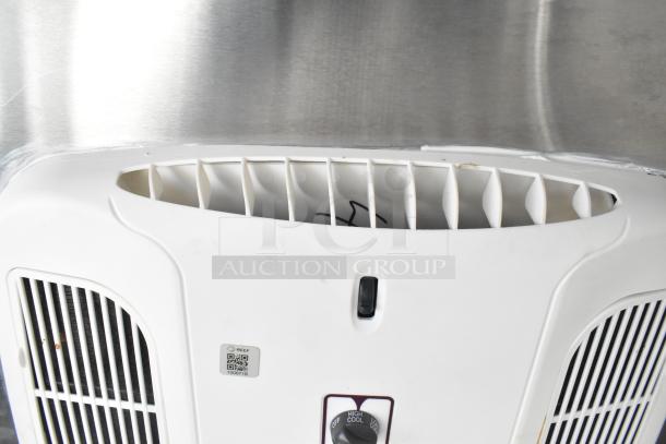 White air vent with adjustable control switch and QR code on a metal backdrop, part of a 2021 Rock Solid Cargo trailer.