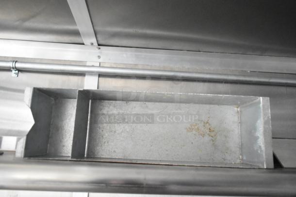 Interior view of a brand new 2021 Rock Solid Cargo fast food trailer. Image shows a metallic compartment, part of the mobile kitchen’s fixtures.