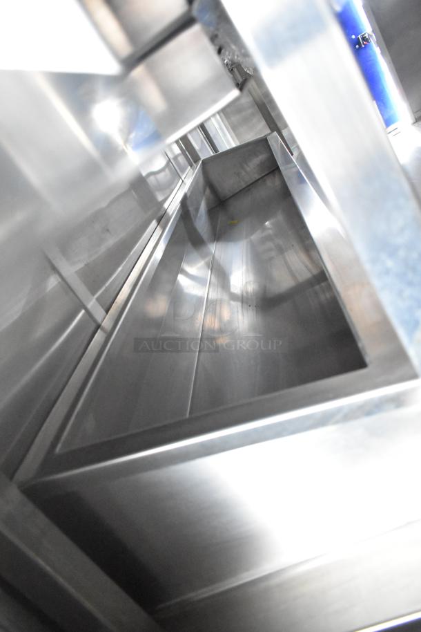 Interior view of brand new 2021 Rock Solid Cargo 24' mobile kitchen trailer with stainless steel sink.