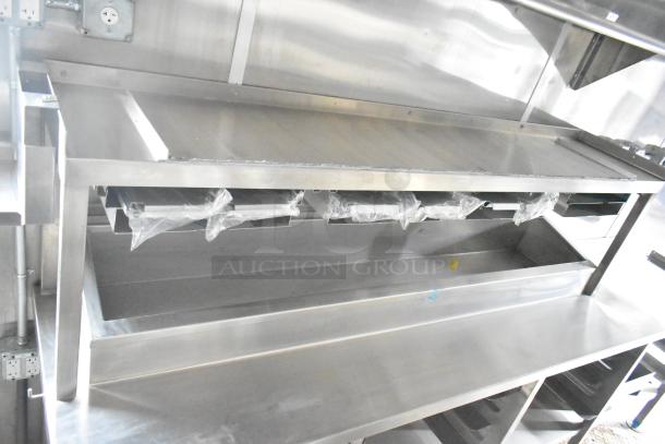 Brand new 2021 Rock Solid Cargo 24' mobile kitchen trailer, stainless steel interior with commercial-grade equipment, including CaptiveAire grease hood, sinks, and fixtures.