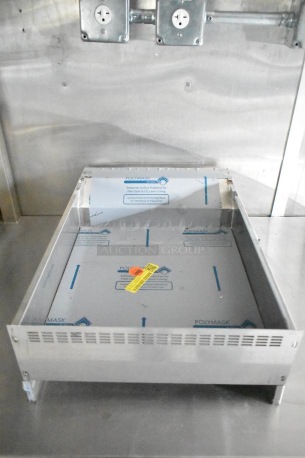 Brand new Rock Solid Cargo trailer interior, featuring an unused appliance with protective Polymask covering.