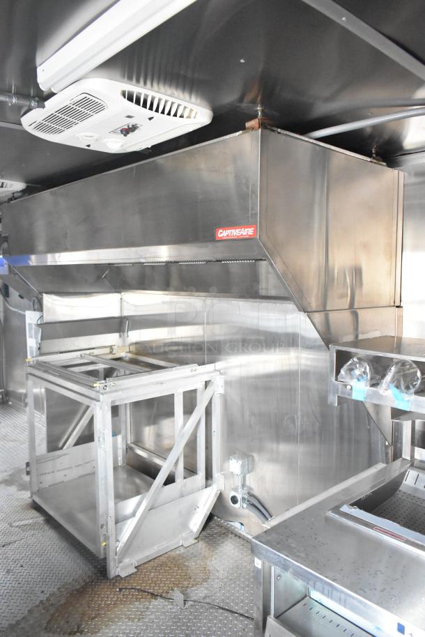 Brand new 2021 Rock Solid Cargo 24' mobile kitchen trailer, featuring a CaptiveAire grease hood and stainless steel fixtures.