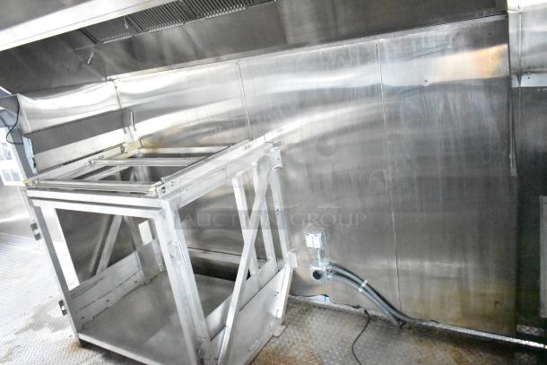 Brand new 2021 Rock Solid Cargo 24' mobile kitchen trailer interior with CaptiveAire grease hood and stainless steel fixtures.