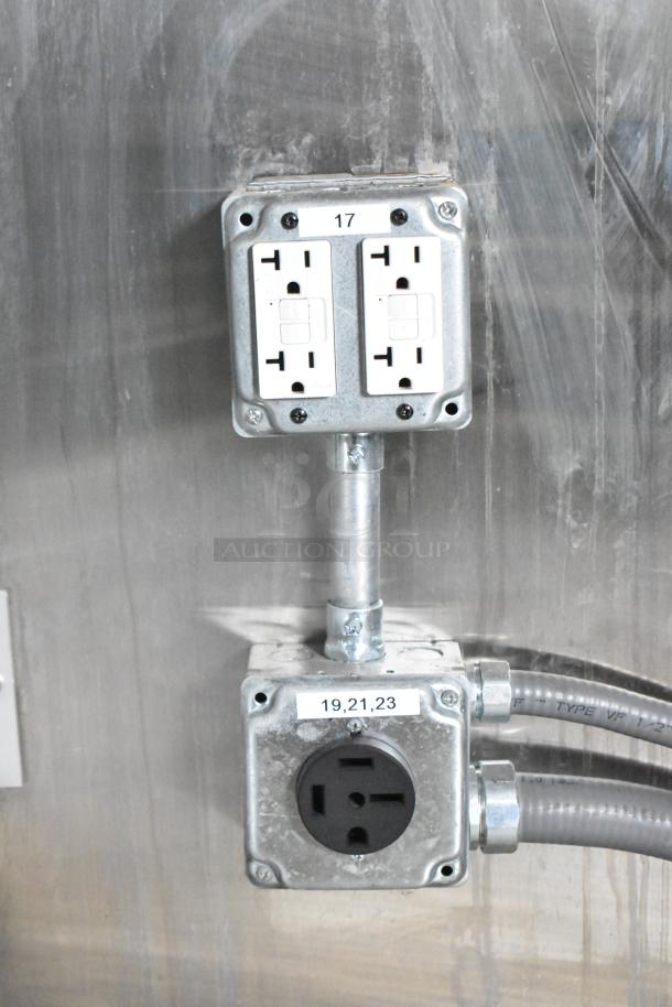 Electrical outlets and wiring inside a 2021 Rock Solid Cargo 24' mobile kitchen trailer. Features standard and high-voltage sockets.