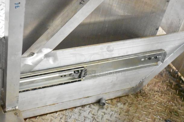 Interior detail of 2021 Rock Solid Cargo 24' mobile kitchen trailer, showcasing metal framework and industrial-grade equipment base.