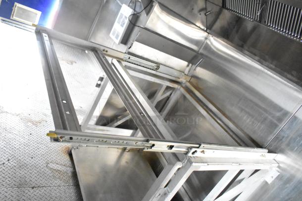 Brand new 2021 Rock Solid Cargo 24' fast food trailer interior with stainless steel kitchen setup, including CaptiveAire hood.