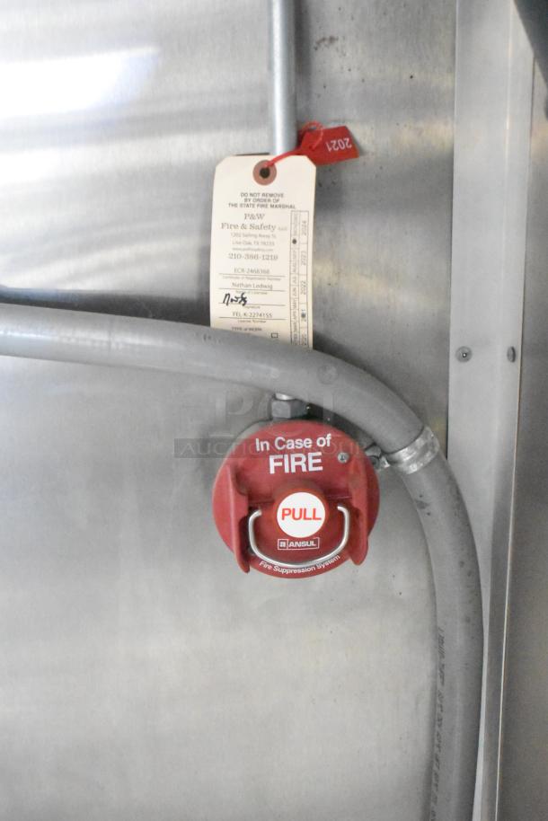 Fire suppression system pull handle for 2021 Rock Solid Cargo mobile kitchen. Includes safety inspection tag.