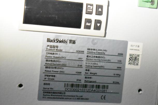 Close-up of BlackShields DC0300 label showing specifications: power supply -48V, rated power 125W, and cooling capacity 300W.