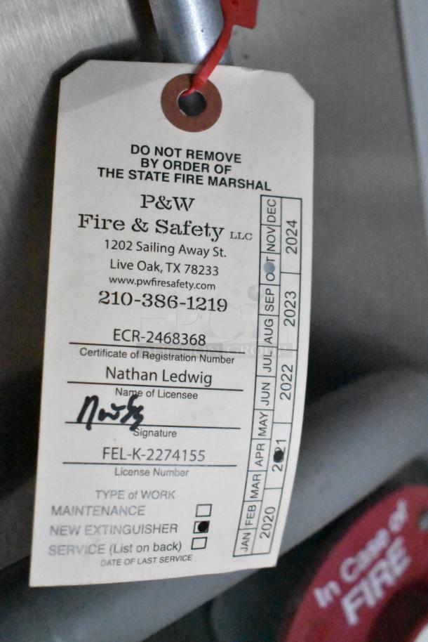"New fire extinguisher tag from P&W Fire & Safety, showing maintenance completed with registration details and dates."