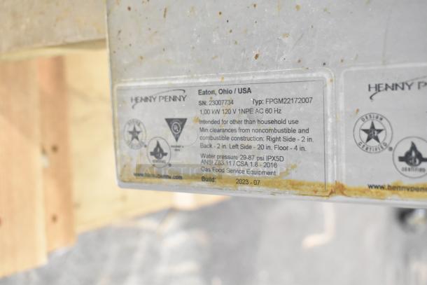 Label on 2023 Henny Penny FPGM22172007 commercial convection oven shows serial and model numbers, power, and safety info.