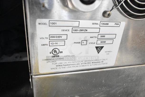 Wittco 1001 Commercial Heated Holding Cabinet label showing model, serial number 725499, 208/240V, 1 phase, UL listed.