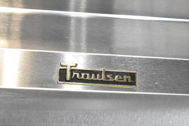 Traulsen G12010 commercial reach-in freezer, single door, on casters, 115V, 1 phase, brand logo visible on stainless steel.