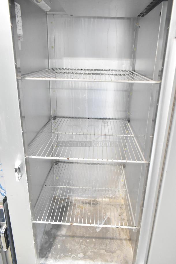 Traulsen G12010 commercial single door reach-in freezer with shelves, on casters. Shows interior condition. 115V, 1 phase.