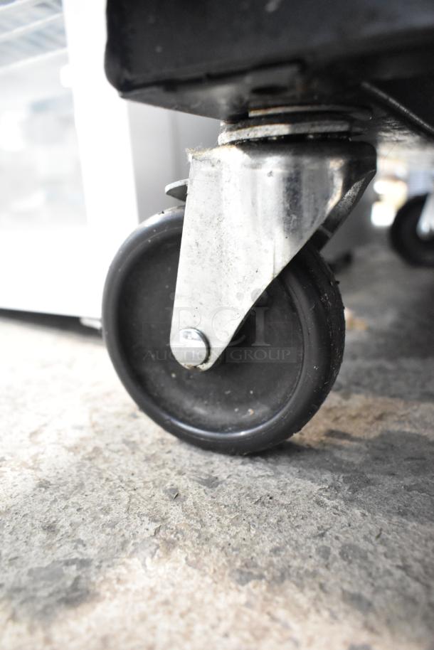 2019 True T-49F-HC freezer caster, highlighting sturdy metal frame and smooth rolling wheel for easy mobility.