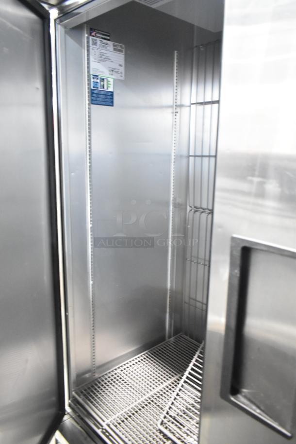2019 True T-49F-HC commercial 2-door reach-in freezer, stainless steel interior, visible shelving, excellent condition.